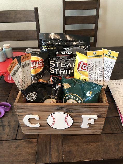 Baseball wood basket for boyfriend’s birthday.   SF Giants and Oakland Athletes Tickets and matching peanuts with Costco beef jerky and our favorite chips. Baseball Gift Basket For Boyfriend, Baseball Basket Ideas, Baseball Basket Ideas For Boyfriend, Baseball Gifts For Boyfriend, Birthday Baskets For Boyfriend, Sports Gift Basket, Baseball Gift Basket, Baseball Boyfriend Gifts, Basket For Boyfriend