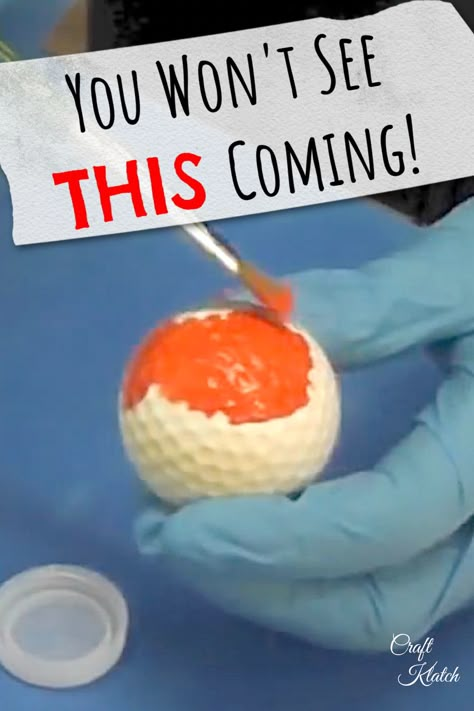 white golf ball being pained orange with a paint brush Golf Ball Decor, Upcycle Golf Balls, Crafts With Golf Balls, Golf Balls Crafts Ideas, Painted Golf Balls Cute Ideas, Golf Diy Crafts, Golf Tee Crafts, Golfball Crafts, Golf Club Crafts