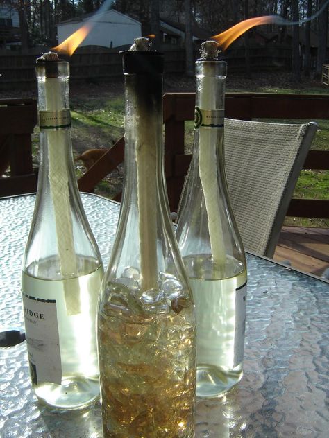 DIY: Wine Bottle Tiki Torches...great idea for those left over bottles Wine Bottle Tiki Torch Diy, Diy Tiki Torch, Wine Bottle Torches, Bottle Torch, Torches Tiki, Wine Bottle Tiki, Wine Bottle Tiki Torch, Windowsill Garden, Empty Wine Bottles