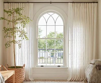 Curtains for Arched Windows: Design Tips | The Shade Store Types Of Drapes, Ripplefold Drapery, Curtains For Arched Windows, Curved Curtain Rods, Arched Window Treatments, Ripplefold Draperies, Antique Home Decor Ideas, Vintage Lace Curtains, Window Treatments Ideas