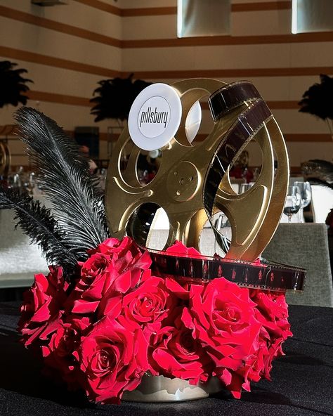 Lights, camera, feathers! 🎬✨ Our latest event decor brings Hollywood glamour to life with a touch of elegance. From black ostrich feathers to golden film reels and radiant red roses, these centerpieces are ready to steal the spotlight! 🌹✨ Perfect for weddings, galas, and beyond! • • • #ostrichfeathers #ostrichfeathercenterpieces #rentfeathers #weddinginspiration #weddingdecor #tablesetting #tablescape #tablestyling #blackostrichleather #greatgatsbyparty #corporateevents #eventdecor #eve... Old Hollywood Glamour Centerpieces, Red Feather Centerpieces, Harlem Nights Theme Centerpieces, Hollywood Glam Party Ideas, Black Ostrich Feather Centerpiece, Red Carpet Event Centerpieces, Hollywood Table Decorations, Old Hollywood Table Decor, Hollywood Theme Centerpieces