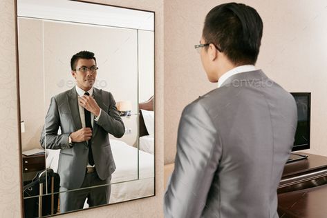 Adjusting tie by DragonImages. Young Asian businessman getting ready in front of big mirror #Sponsored #Young, #Asian, #DragonImages, #Adjusting Standing In Front Of Mirror Reference, Man Adjusting Tie, Man In Front Of Mirror, Standing In Front Of Mirror, Dragon Images, Big Mirror, Photo Texture, U Turn, Model Drawing