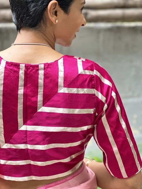 In line with our dedication to producing unique, versatile blouses with meticulous attention to detail, is this bright pink mashru silk blouse with silver stripes that is tailored to perfection. Designed for year-round comfort, this blouse has a high back to flaunt those perfect angles and a low back with front open. Single Strip Blouse For Lehenga, Stripe Blouse Designs, Strip Blouse Design For Saree, Single Strip Blouse, Striped Blouse Designs For Saree, Front Open Blouse Designs, Back Open Blouse Designs, Pink Semi-stitched Tussar Silk Blouse Piece, Striped Blouse Designs