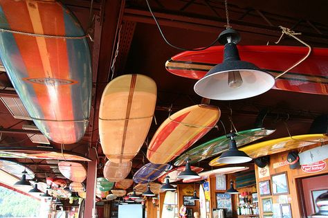 ceiling of the beach house Surfboard Ceiling, Surf Restaurant Design, Surf Cafe Design, Surfboard On Ceiling, Surfboard Bar, Surfboard Light Fixture, Surf Cafe, Floating Ceiling, Surfboard Storage