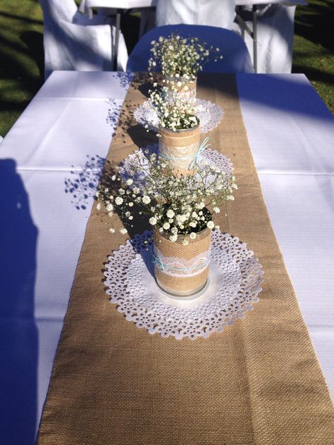 Burlap runners, tins covered with burlap and lace Baby Shower Burlap Table, Italian Decorations, Burlap Table Decorations, White Table Cloths With Burlap Runners, Burlap Table Runner With Wood Centerpiece, Black Table Cloth With Burlap And Lace Runner, Lace Tablecloth With Burlap Runner, Country Table Runner, Burlap Runners