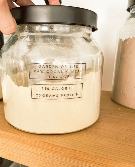 Tuesday's Tip! When decanting protein powder, use a more general label on the front such as the flavor or type of protein while the brand and nutrition facts can be on another label on the back or the bottom of the container. Protein powders are amazing but the packaging is never clean enough to display in the kitchen so glass jars are a great addition and an easy way to keep track of when you need a replacement. #unclutteredbydesign #homeorganization Protein Powder Storage, Protein Powder Organization, Protein Powder Container, Protien Powders, Pantry Storage Containers, Pantry Storage, Storage Hacks, Protein Bars, Kitchen Redo