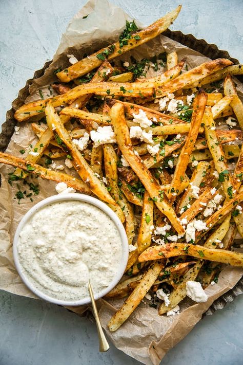 Dressed with extra virgin olive oil, salt, pepper and oregano, these oven-baked fries are inspired by the traditional Greek taverna favorite, patates tiganites. Fries Recipe Oven, Greek Taverna, Greek Fries, Baked French Fries, Oven Baked Fries, Yummy Fries, Greece Food, The Modern Proper, Modern Proper