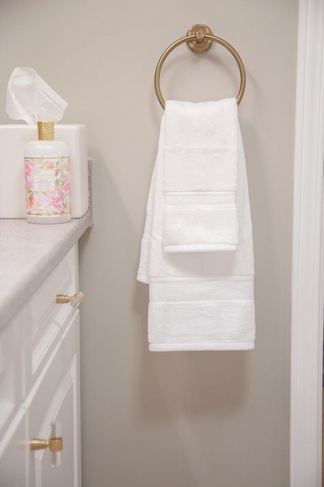 Layer hand towels on a towel ring to decorate a bathroom. #towelring #brass #bathroom #towel #storage #decorate White Hand Towels Bathroom, Towel Rings In Bathroom, Hand Towel Placement Bathroom, Towel Ring Placement Bathroom, Refresh Bath Towels, Bathroom Hand Towel Ideas, Lakehouse Bathroom, Decorate A Bathroom, Hanging Bath Towels