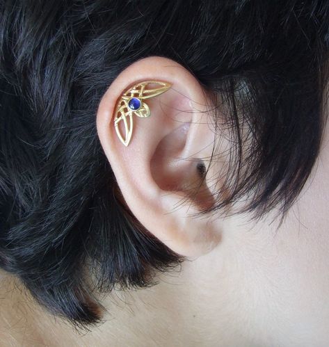 "This is a single helix piercing with intertwining Celtic designs. It comes as a single ear piercing, and fits both ears. It is made of 14k gold and stamped 14k on the backside. You can choose yellow, rose, or white 14k gold plating when you order. I plate the white gold with rhodium plating, as common in white gold jewelry. You can also choose the finish you want for the earring - matte ( as seen in pictures ) or shiny. In the pictures, you can see the earring with a blue topaz stone, which is Funky Helix Ring, Helix Piercing Jewelry Spirit Adornments Piercing Jewlery, Cheap Metal Cartilage Earrings For Gifts, Pretty Helix Earrings, Helix Jewelry Cartilage Piercings, Curved Helix Earring, Hidden Helix Jewelry, Single Helix Piercing, Single Ear Piercing