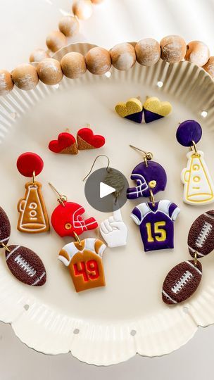 45 reactions · 5 comments | Football starts this week!! 🏈👏🏻  And so does this Collection ❤️ I’m a little behind on getting these out, but better late than never! 😆  Choose your favorite style of earrings, favorite number, and team colors and personalize it to your liking ❤️💙🧡  What’s your football team? Comment below! ⬇️   Football Collection coming Wednesday to the shop! Save the date! • • • • • • • •  #polymerclaycreations #polymerclayjewelry #fallfashion  #clayjewelry #fallstyle  #handmadeearrings #hypoallergenic  #sports #fallvibes #fall  #earringsoftheday #football #footballjewelry🏈 #footballgames #footballseason #nfl   #love #polymerclay #autumnvibes #smallbusiness #etsy #falljewelry #footballearrings #footballjewelry | Clovers and Clay | ROKKA · Game Day Football Polymer Clay Earrings, Football Clay Earrings, Football Jewelry, Clay Earring Ideas, Football Diy, Magnet Ideas, Favorite Number, Football Earrings, Polymer Clay Figures