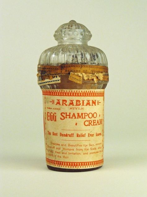 This unusual bottle of Arabian Style Egg Shampoo Cream came to the Smithsonian Museum from the Georgetown Pharmacy of Washington, D.C., after the pharmacy closed in 1988. Promoted in advertisements as a “beautifier and grower,” this product appears to have been available from about 1895 to 1920. In 1913 it was advertised for 18 cents at a Washington Rexall drugstore. Protein and other nutrients found in eggs are thought to enhance hair’s health. Egg Shampoo, Poison Bottles, Smithsonian Museum, Makeup Salon, Commercial Art, Apothecary Jars, Museum Collection, Glass Containers, Vintage Hairstyles