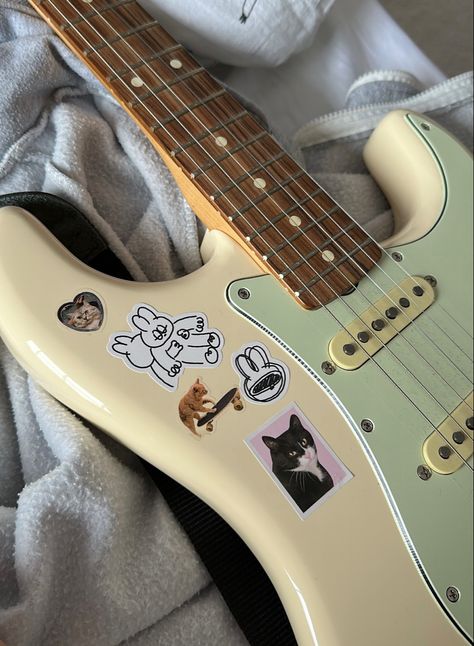 my guitar with stickers Electric Guitar Sticker Aesthetic, Decorated Guitars Stickers, Guitar With Stickers Aesthetic, Stickers On Guitar Acoustic, Electric Guitar With Stickers, Guitar Stickers Aesthetic, Guitar Stickers Ideas, Stickers On Guitar, Stickers On Everything