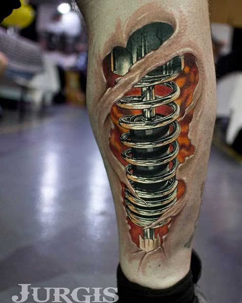 Realistic shock absorber biomechanical lower leg piece. Tattoo by Jurgis Mikalauskas, an artist based in Peterborough, England. Shock Tattoo, Piston Tattoo, Ripped Skin Tattoo, Biomech Tattoo, Tato 3d, Biomechanical Tattoo Design, Robot Tattoo, Tatoo 3d, Mechanic Tattoo