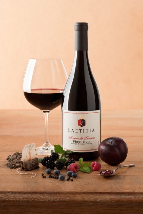 Laetitia Reserve du Domaine Pinot Noir shows focused tannin and velvet-like texture combined with dark berry tones and deep toast for an abundance of mid-palate richness. Damp earth and earl grey tea compliment and round out the olallieberry jam flavors. Jam Flavors, Red Wine Product Photography, Moody Wine Photography, Wine Bottle Photography, Most Expensive Wine, Expensive Red Wine, Berry Tones, Most Expensive Wine In The World, Fruit Wine