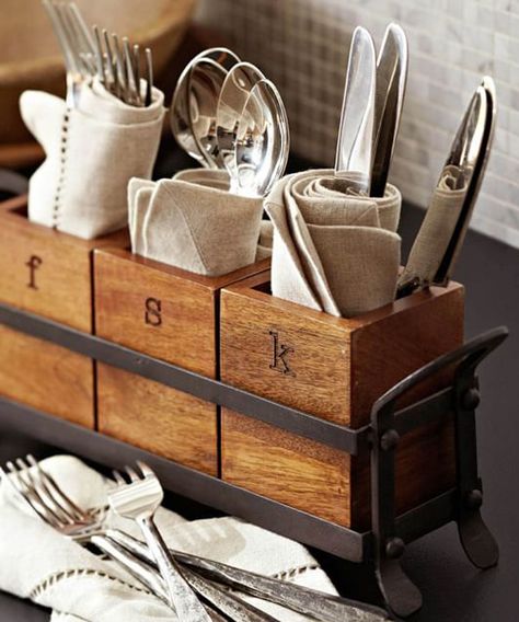 Vintage Flatware Caddy Vintage Flatware Caddy: Vintage Blacksmith flatware Caddy. Three mango wood coffers are set inside a blackened iron frame to create this handsome caddy, perfect for sharing serving utensils, napkins and flatware. Curved handles make it easy to pass around the table. Essential Kitchen Items, Kitchen Caddy, Flatware Caddy, Vintage Flatware, Cutlery Holder, Entertaining Essentials, Decorative Pottery, Kitchen Items, Mango Wood