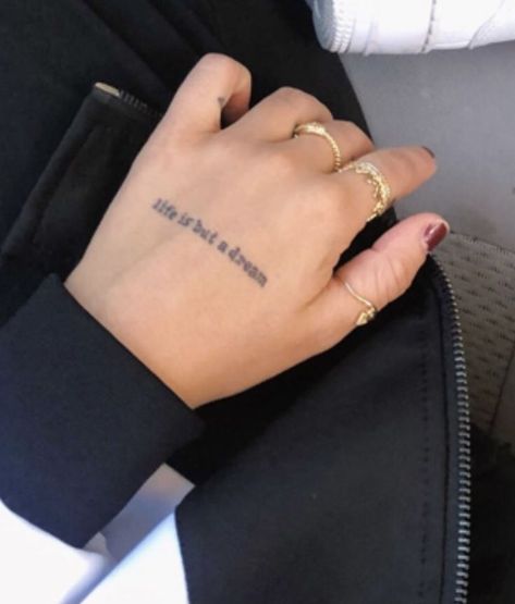 Words Hand Tattoos For Women, Phrase Hand Tattoo, Life Is But A Dream Tattoo, Words Hand Tattoo, Hand Text Tattoo, Word Hand Tattoos, Tattoo Sentences, Believe Tattoos, Dna Tattoo