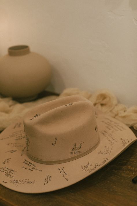 wedding guest book cowboy hat Cowboy And Cowgirl Wedding Ideas, Cowboy Hat Wedding Guest Book, Cowboy Hat Signing Wedding, Cowboy Hat Guest Book Sign, Halo Themed Wedding, Country Cowboy Wedding, Western Table Setting Wedding, Wedding Inspiration Western, Western Romance Wedding