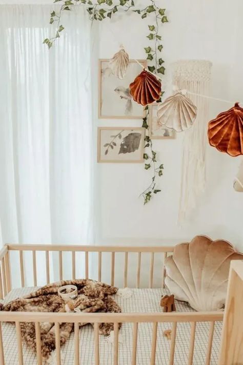 If you're looking for a theme for your baby's nursery, why not consider an under-the-sea theme? From playful sea creatures to serene ocean colors, an under-the-sea nursery can create a calming and imaginative environment for your little one. Here are 21 spectacular under-the-sea nursery ideas to inspire you. Shell Nursery Theme, Beachy Nursery Ideas, Boho Mermaid Nursery, Little Mermaid Nursery Theme, Coastal Nursery Girl, Beach Nursery Theme, Ocean Nursery Girl, Seashell Nursery, Boho Beach Nursery