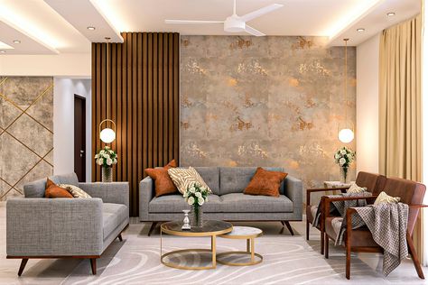 The grey textured fabric used in the wooden-framed sofa set with brown cushions adds a contrast to the room. Two brown accent chairs on the side complement the pale grey rug. The textured wall with a tint of gold and side wooden panelling enhances the look. A round nesting table with black and white marble table top and gold framework matches well with the overall interior. Living Area Wallpaper, Wooden Frame Sofa, Living Room Indian, Wallpaper House Design, Wooden Panelling, Drawing Room Interior, Drawing Room Interior Design, Latest Living Room Designs, Gold Living Room