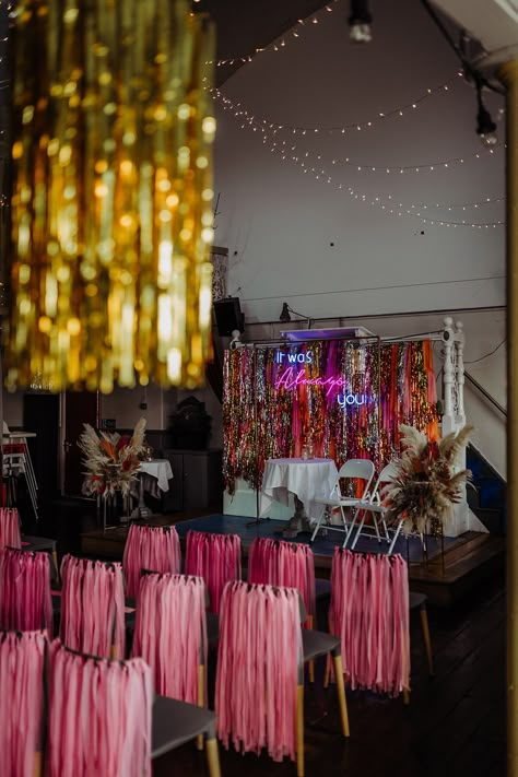 Pink, orange, gold and silver metallic streamer backdrop with pink streamers on the back of chairs, gold streamers on the lights and fairly lights hung up on the ceiling Gold Streamer Backdrop, Pink Streamers, Gold Streamers, Cat Stephens, 36 Birthday, Wedding Streamers, Wedding Diys, Orange And Pink Wedding, Disco Wedding