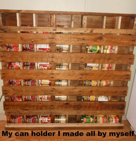 I made my own can storage rack from an old pallet.... After I took off the back boards, I put a piece of paneling on it . Put in more 1 x 4's  to make separate bins for dif veggies. It def freed up space in my pantry. Then I did a little sanding and staining and there ya go. It does have a free space for really small cans. I think I will put wheels on it and slide it behind an appliance out of the way. Diy Can Storage, Pallet Pantry, Canned Good Storage, Wooden Pantry, Repurpose Pallets, Pallet Crates, Canned Food Storage, Pallet Projects Furniture, Can Storage