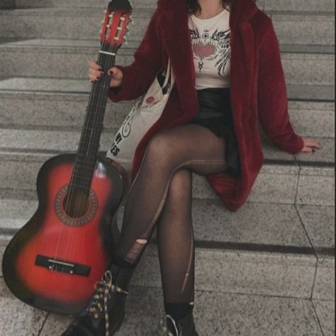 Girl sitting on stairs while holding a red guitar. She's waring a red fur coat with a black leather skirt and ripped tights. Body And Style Style Roots, Rockstar Outfits Aesthetic, 90s Pop Punk Aesthetic, Red Fits Aesthetic, Grunge Rockstar Aesthetic, Arabella Aesthetic, Rock Aesthetic Outfits, Rockstar Aesthetic Outfits, Thrift Board