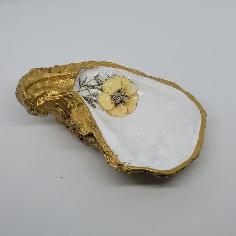 New Handcrafted Shell Is Painted Gold With Gold Trim Decoupage Yellow Flower In Center Of Medium Shell Sealed With Poly Great For Bedroom Or Near Sinks Perfect For Weddings Or Gifting Yell Flower 2 Shell Ring Holder, Shell Ring, Oyster Shell, Trinket Tray, Yellow Flower, Gold Trim, Ring Holder, Yellow Flowers, Home Accents