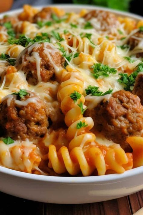 Closeup of a serving of Dump and Bake Meatball Casserole in a white bowl, highlighting the gooey mozzarella cheese, meatballs, and rotini pasta. Dump And Bake Dinners, Dump And Bake Meatball Casserole, Rotini Pasta Recipes, Cheese Meatballs, Cozy Soups, Dump And Bake, Chicken Mozzarella, Mozzarella Pasta, Meatball Casserole