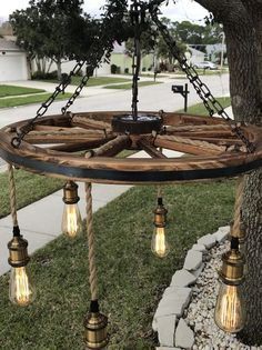 easy woodworking projects that sell. Wagon Wheel Light, Wagon Wheel Decor, Diy Lampe, Wheel Decor, Outdoor Chandelier, Wheel Chandelier, Wooden Wheel, Vintage Bulbs, Wagon Wheel Chandelier