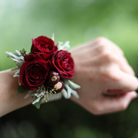 wrist corsage with Rubicon spray roses, buckeyes, dusty miller and seeded eucalyptus on a platinum pearl wristlet Wrist Corsage Prom, Rose Corsage, Corsage And Boutonniere, Corsage Prom, Winter Rose, Prom Flowers, Flower Corsage, Corsage Wedding, Wrist Corsage