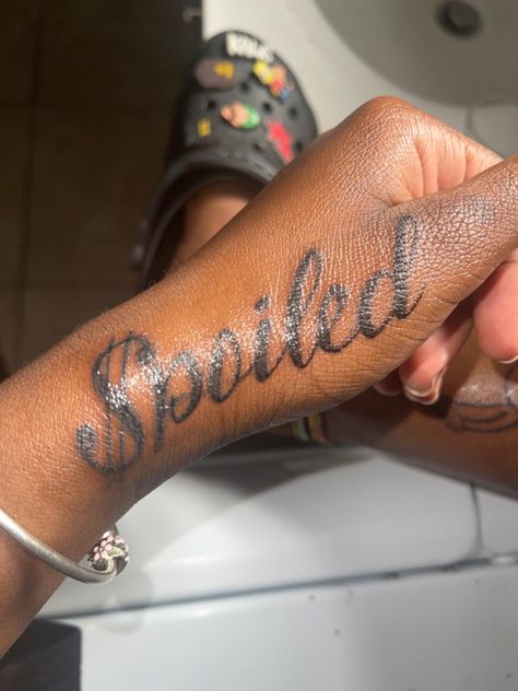 spoiled girl tattoo 
tattoos for girls Spoiled Tattoo Ideas, Female Hand Tattoos Ideas, Sleeve Baddie Tattoo, Spoiled Tattoo, Black Female Hand Tattoos, Lil Tattoos, Thug Tattoos For Women Arm, Tattoo Ideas Female Wrist, Princess Tattoo Ideas