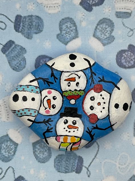 "Four Snowmen in a Circle, Winter Christmas Painted Rock Measures approximately:  Height 2.75\" Length 2.25\" Depth .5\" ✽ My painted rocks are natural creek rocks collected locally in middle Tennessee and hand painted by me.  ✽ Your stones are handpicked and hand painted by me with love! Each is a one-of-a-kind piece of art! I hope they bring much joy, happiness, and a smile to you.   ✽ These are natural creek rocks so each stone is unique and no two rocks are identical.  The size, shape, and texture may vary slightly. ✽ Each stone design is drawn by hand, painted with acrylic paints, sealed, and packaged with care to send to your home from my home in middle Tennessee.   ✽ All my creations are sealed to protect and preserve the quality. ✽ Want a custom design?  If you don't find exactly w Painted River Rocks, Stone Art Painting, Christmas Rock, Painted Rocks Craft, Middle Tennessee, Snowman Painting, Rock Painting Patterns, Rock Painting Designs, Rock Painting Art