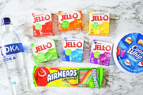 Rainbow Jello Shots are made by layering vibrantly fruity jello mixed with vodka into small cups, and topping it off with Cool Whip and Rainbow Berry Airheads to finish. They are so cute and colorful, they are the perfect adult-only treats for any summer gathering or barbecue. Non Alcoholic Jello Shots Kids, Colorful Jello Shots, Jello Shots With Whipped Cream Vodka, Fruit Jello, Rainbow Jello Shots, Rainbow Shots, Jell-o Shots With Whipped Vodka, Pineapple Jello, Jello With Fruit