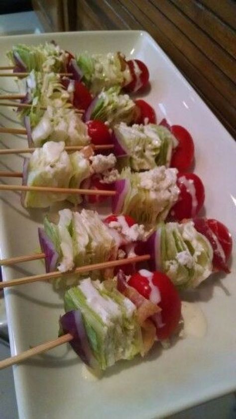 Wedge Salad on a Stick 8 	(1-inch) wedges iceberg lettuce 4 strips 	cooked bacon, cut in half 8 	grape tomatoes 8 	bamboo toothpicks 8 teaspoons 	blue cheese salad dressing 8 teaspoons 	crumbled blue cheese, or more to taste Salad On A Stick, Wedge Salad, Resep Salad, Quick And Easy Appetizers, Snacks Für Party, On A Stick, Idee Pasto Sano, Harvest Festival, Party Food Appetizers