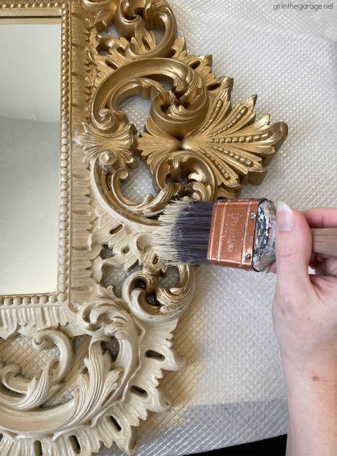 How to paint something to look like wood, like this gaudy gold plastic mirror. This easy makeover is a stunning update! By Girl in the Garage Gold Paint For Furniture, Wood Mirror Frame Makeover, How To Paint A Mirror Frame, Painted Mirrors Ideas, Diy Ornate Mirror, Painted Mirror Frame Ideas, Painting Frames Ideas, Ornate Mirror Makeover, Refinish Mirror Frame