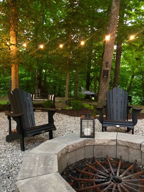 Fire Pit Ideas Woods, Lakefront Fire Pit Ideas, House In Woods Landscaping, Backyard With Lots Of Trees, Landscape Around Fire Pit Area, Pebble Fire Pit Area, Cottage Fire Pit, Pea Gravel Fire Pit Area, Gravel Fire Pit Area