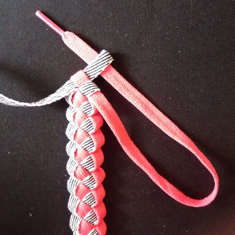 Here’s a bit of a throwback — weaving ribbons, but in this case, shoelaces.     Step 1: Fold the shoelaces together 3 to 5 inches from the aglet (the end of a shoelace). That … Shoe Lace End Knot, Shoe Lace Bracelet Diy, Shoelace Bracelet Diy, Hockey Lace Crafts, Shoe Lace Bracelet, Shoelace Crafts, Diy Bracelets With Names, Dog Toy Ideas, Shoelace Bracelet