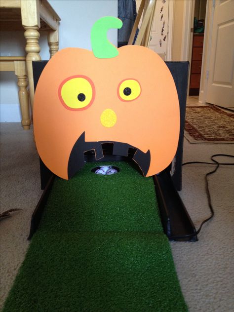 Halloween Putting Pumpkin.   Granddaughters are having a Halloween Birthday Party  so take a golf putting green, box painted black and go to Micheal's and get this foam  pumpkin and glue on front of box.  Set box over hole.  Have the ifs putt the golf ball in the pumpkins mouth.  I am using yellow golf balls. Mini Golf Trunk Or Treat, Pumpkin Golf Game, Pumpkin Putt Putt Golf, Halloween Mini Golf Diy, Golf Trunk Or Treat Ideas, Halloween Putt Putt Golf, Halloween Putt Putt, Pumpkin Putt Putt, Halloween Mini Golf