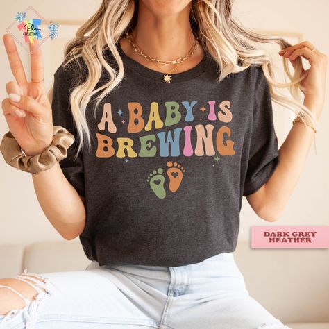 A Baby Is Brewing Pregnancy Announcement Maternity Shirt Baby Brewing Pregnancy Shirt Pregnancy Announcement Shirt, Pregnancy Humor, Pregnancy Shirts, Pregnancy Reveals, V Neck Tee, Black Design, Baby Tshirts, Pregnancy Announcement, Racerback Tank