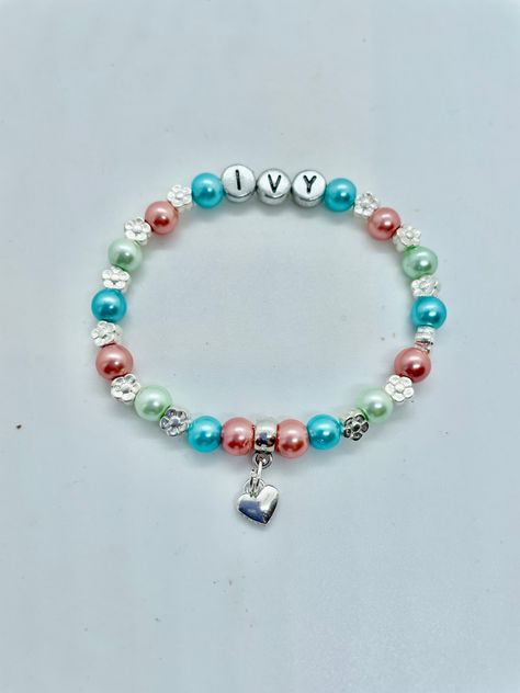 Unique beautiful coloured glass pearl bead bracelet complete with silver hearts or silver flowers at a SUPERB PRICE (limited time only). MANY OTHER FAMILY MEMBERS & WEDDING ATTENDANT Bracelets in my shop. All bracelets are designed and made to order with the charm and colour of your choice for your special Nan (Nanny, Nana, Grandma, Granny). Ideal surprise gift for a PREGNANCY or NEW BABY ANNOUNCEMENT, or Grandparents Day. What grandparent wouldn't love to wear a bracelet with their special gran Bracelet With Name, Pearl Bead Bracelet, Heart Gift Tags, Nanny Gifts, Fairy Charms, Granddaughter Gift, Childrens Jewelry, Personalized Bracelets, Bag Tag