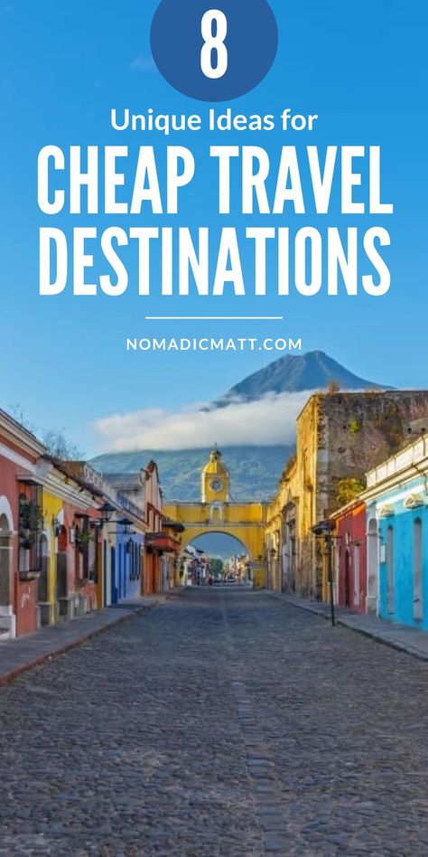 Picture of a town street with a mountain in the background. Text reads: 8 Unique Ideas For Cheap Travel Destinations Travelling Hacks, Cheap Vacation Ideas, Cheap Holiday Destinations, Cheap Vacation Destinations, Cheap Countries To Travel, Cheapest Places To Travel, Cheap Travel Destinations, Vacation Budget, Countries To Travel