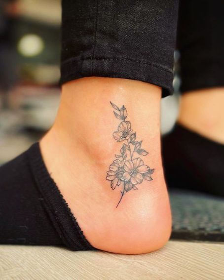 Friendship Ankle Tattoo, Birth Flower Anklet Tattoo, Upper Ankle Tattoos For Women, Small Sunflower Tattoo On Ankle, Outter Ankle Tattoos For Women, Vertical Ankle Tattoos For Women, Mom Ankle Tattoo, Flower Tattoo On Ankle For Women, Cover Ankle Tattoo