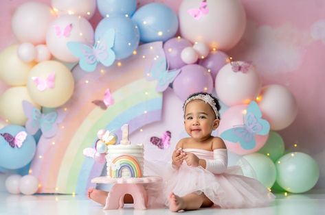 Butterflies And Rainbows Birthday, Smash Cake Colorful, Pastel Rainbow Photoshoot, Rainbow Birthday Photoshoot, Pastel Rainbow Cake Smash, 1st Birthday Rainbow Theme, Rainbow Balloon Backdrop, Pastel First Birthday Party, Butterfly Smash Cake