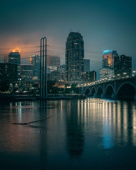 The Minneapolis skyline and Mississippi River at night in Minneapolis, Minnesota Minneapolis Aesthetic, Minnesota Aesthetic, Minneapolis At Night, Pretty Places In Minnesota, Minneapolis Photography Locations, River At Night, Minneapolis Skyline, Twin Cities Minnesota, Skyline At Night