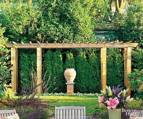 Create a focal point in your backyard with a decorative pergola. This pergola adds depth and dimension to the lushly landscaped yard and provides a framework for one of the owners' favorite sculptures. Garden Focal Point Ideas, Backyard Focal Point, Decorative Pergola, Outdoor Movie Theatre, Garden Focal Point, Mosquito Repellent Spray, Dream Backyard Garden, Court Yard, Backyard Garden Layout