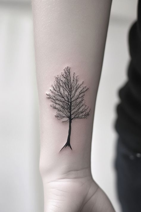 Tattoo of a bare tree with intricate branches on a person's forearm. Tree Wrist Tattoo, Minimalist Tree Tattoo, Small Tattoos With Big Meanings, Small Tattoo Placement Ideas, Minimalist Symbols, Small Compass Tattoo, Small Mountain Tattoo, Tiny Designs, Puzzle Piece Tattoo