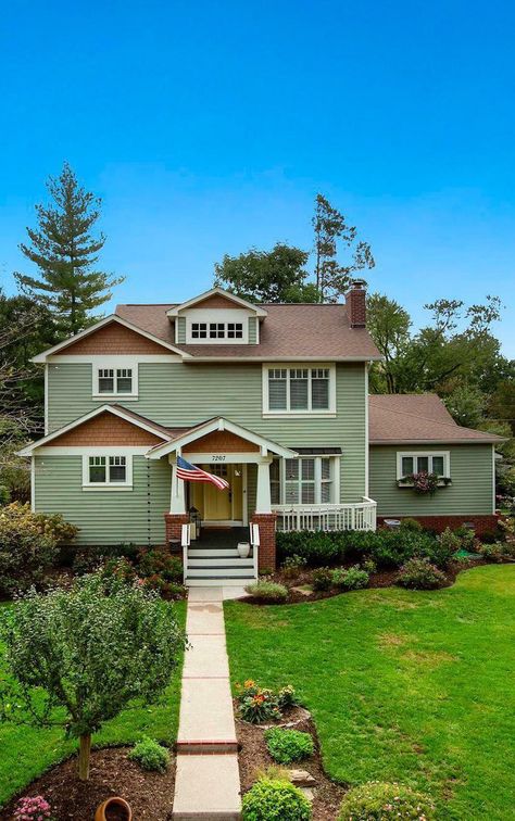 Green siding with brown accents and a brown roof. Green Siding With Brown Roof, Green House Brown Roof, Exterior Paint Colors For House With Brown Roof, Stained Brick Exterior, Green Siding House, Light Green House, Brown House Exterior, Sage Green House, Stained Brick