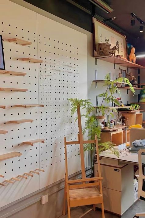 A full wall of pegboard creates a unique and practical office wall design, offering customizable storage and organization options for a modern and functional workspace. Peg Board Walls, Wooden Pegboard, Pegboard Wall, Office Wall Design, Home Greenhouse, Modern Shelving, Modern Minimalism, Simplify Your Life, Wooden Pegs