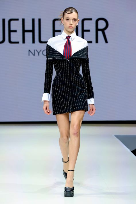 This pinstripe mini dress is all about powerful versatility with a tailored edge. Cut from a richly textured embroidered pinstripe fabric, it brings the polish of suiting into a sleek, structured silhouette. The zip-up front means you control the vibe—wear it off-the-shoulder for a bold, deconstructed look or zip it all the way up for a sharp, high-neck finish. The crisp white shirt cuffs and collar play up the contrast, adding a touch of corporate rebellion. And that bold tie? A nod to traditio Pinstripe Fabric, Suit Dress, Xl Dress, Dresses Xs, White Shirt, Dry Clean Only, High Neck, Sleek, Mini Dress