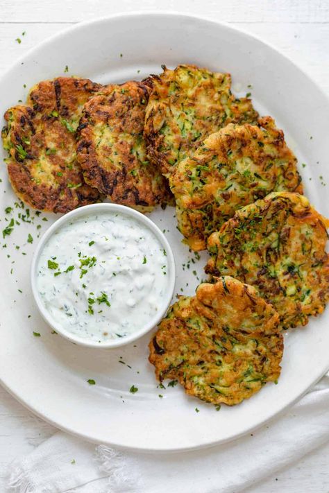 These easy to make Zucchini Fritters make for a great appetizer or side. Wonderfully seasoned, they are a tasty way to get some veggies into your meals! Dinner Zucchini, Sweet Red Chili Sauce, Zucchini Corn Fritters, Zucchini Fritters Recipe, Feel Good Foodie, Zucchini Pancakes, Homemade Tzatziki Sauce, Salad Aesthetic, Homemade Tzatziki